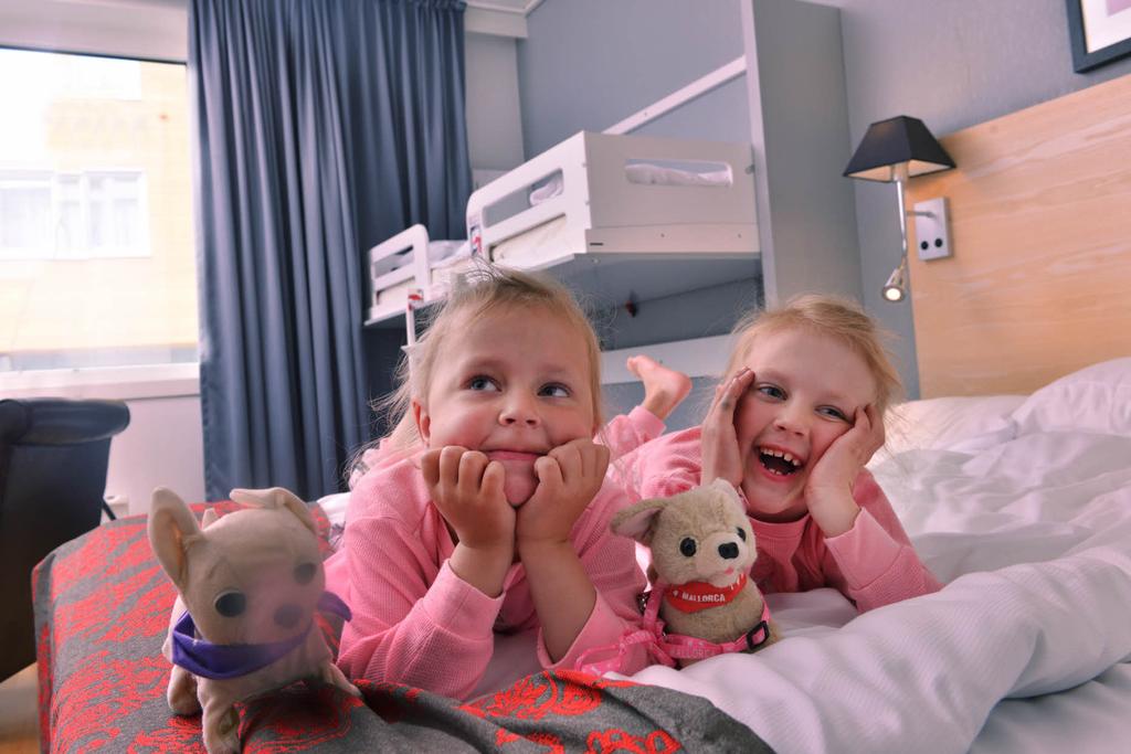 Familyroom with two happy girls in the bed