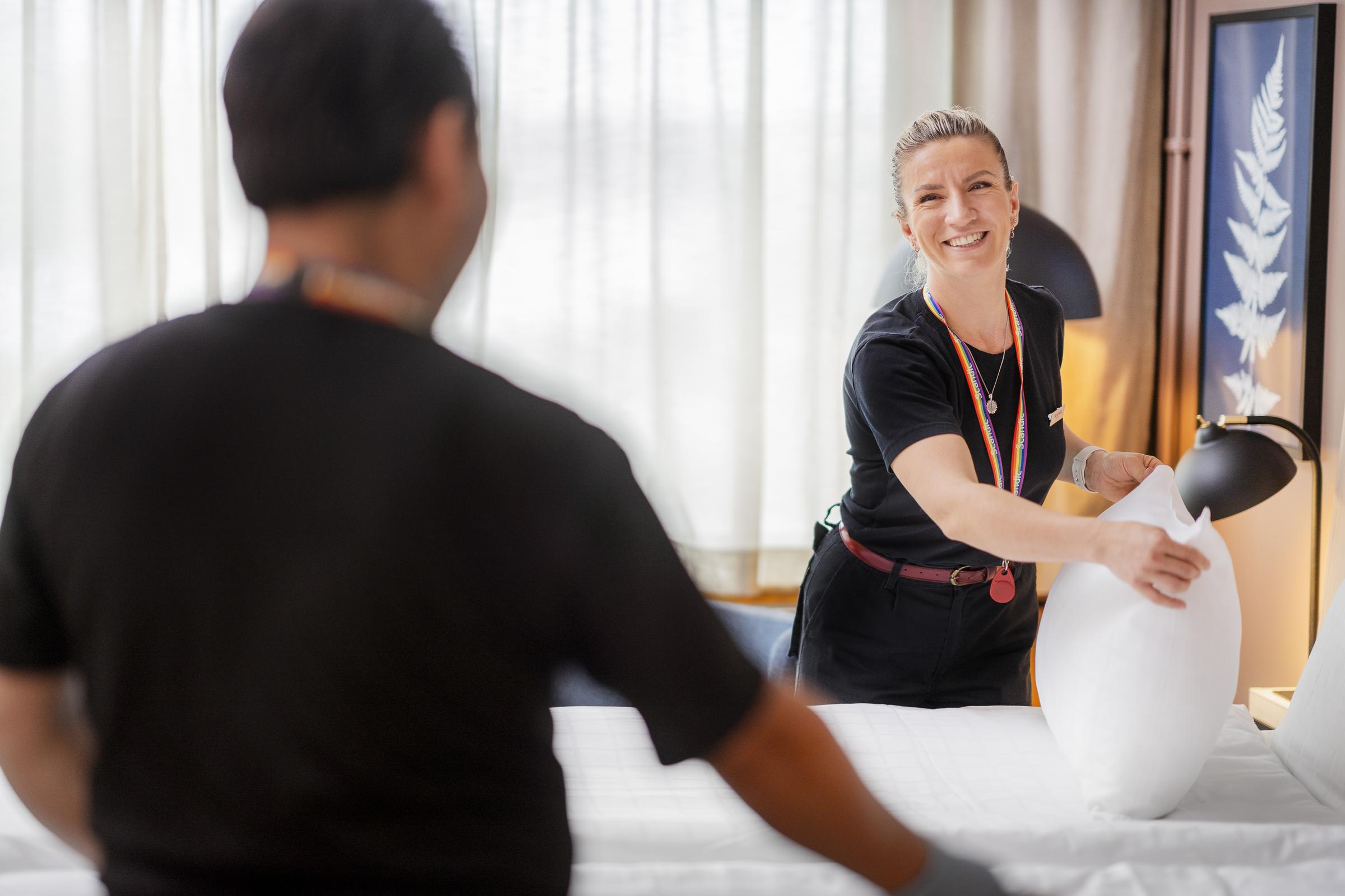 Two team members cleaning a room