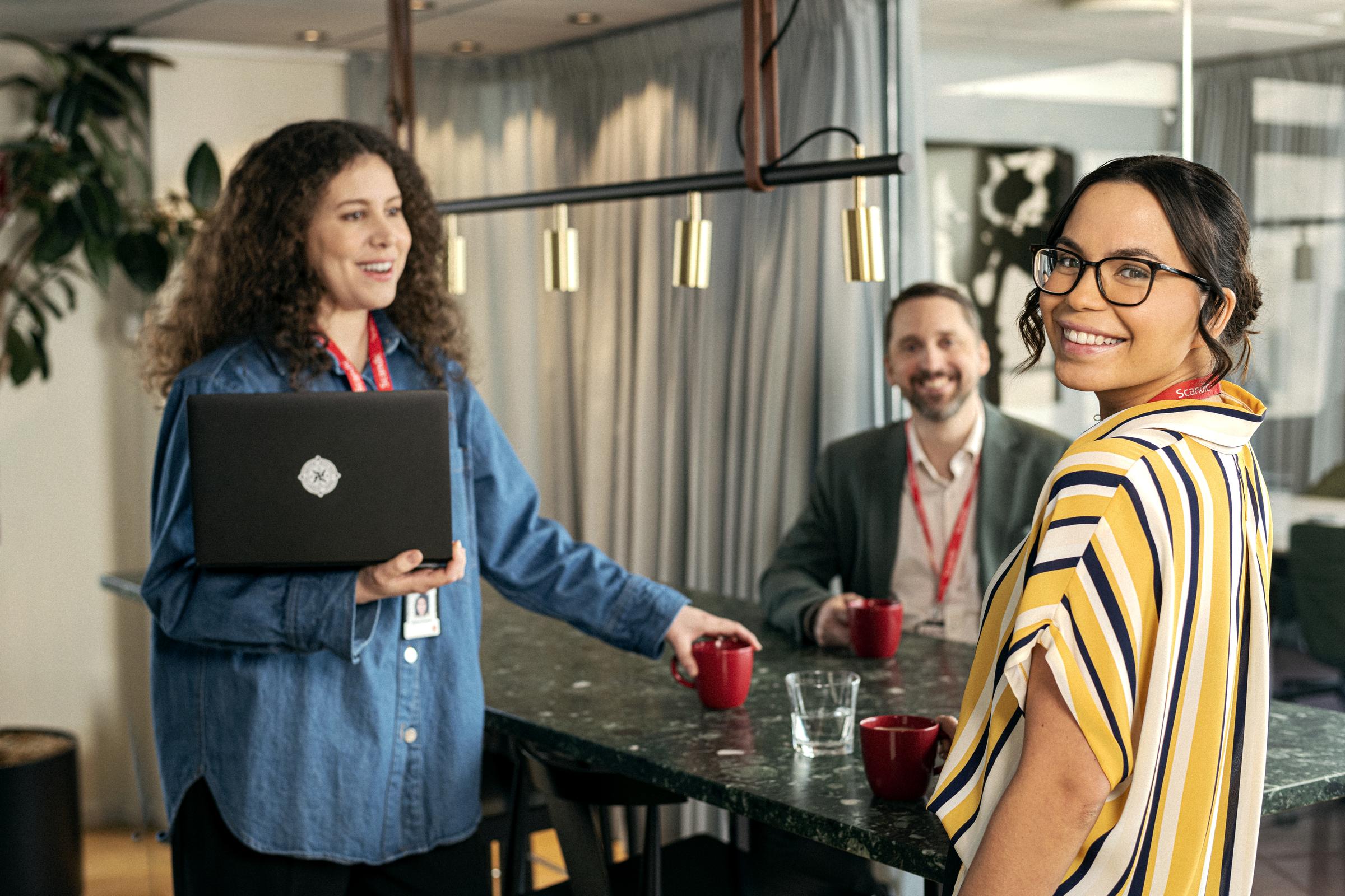Team members talking over a cup of coffee