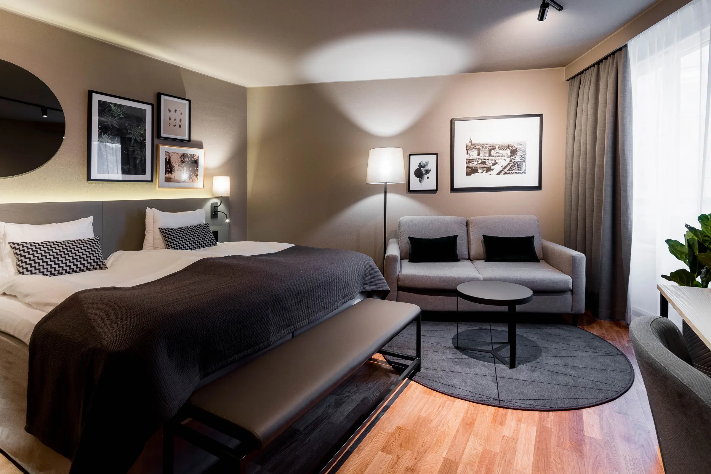Bed and sofa in Family Three Room at Scandic Park in Stockholm
