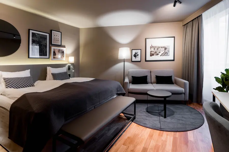 Bed and sofa in Family Three Room at Scandic Park in Stockholm