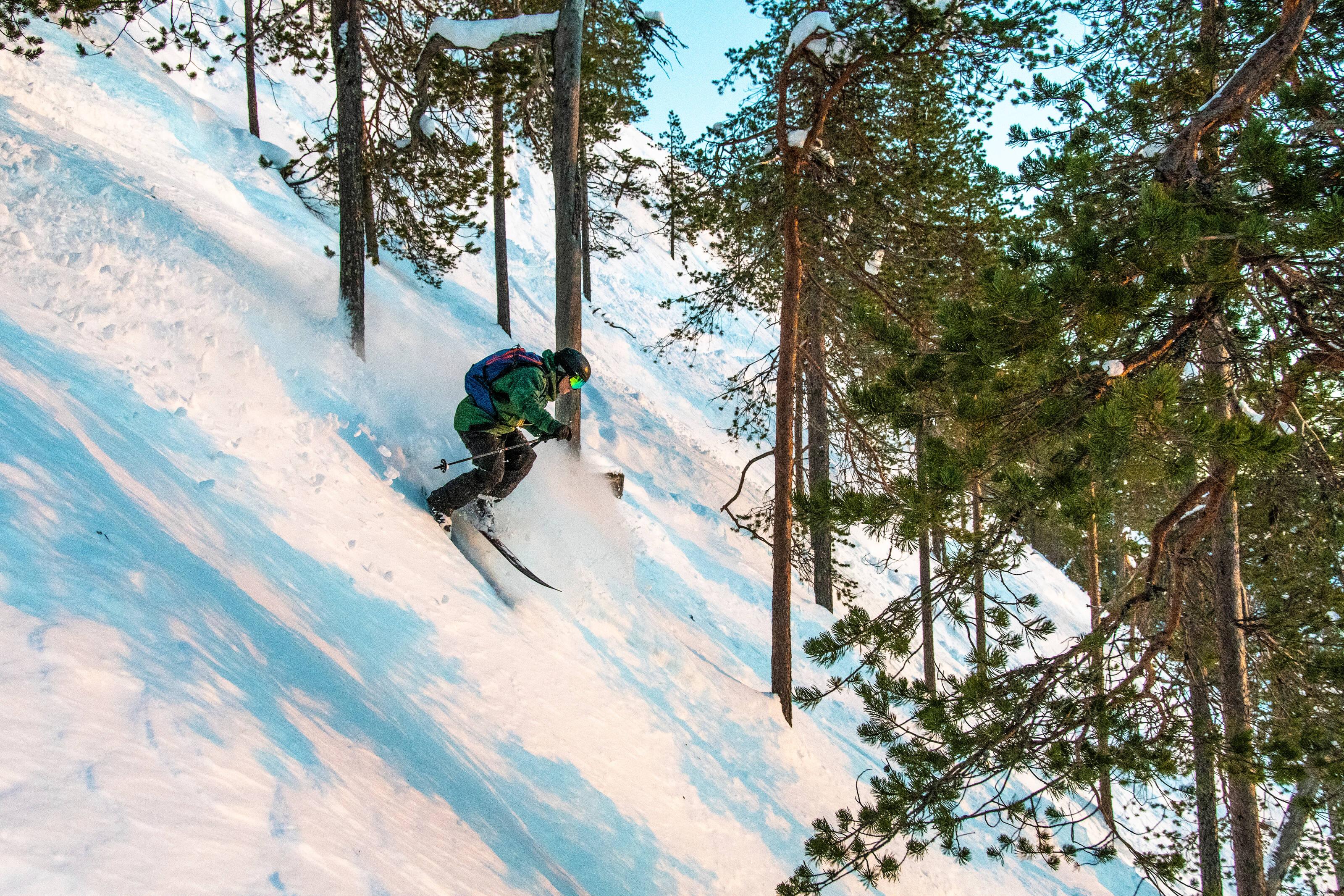A person skiing down a snowy hill in Ruka Finland