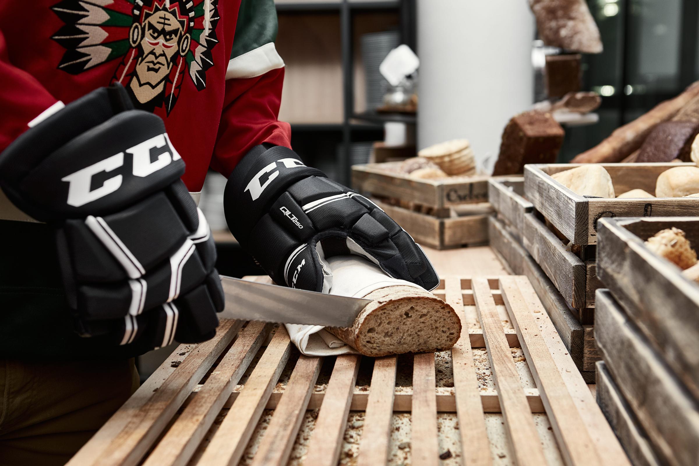Hockey player cutting up bred into slices