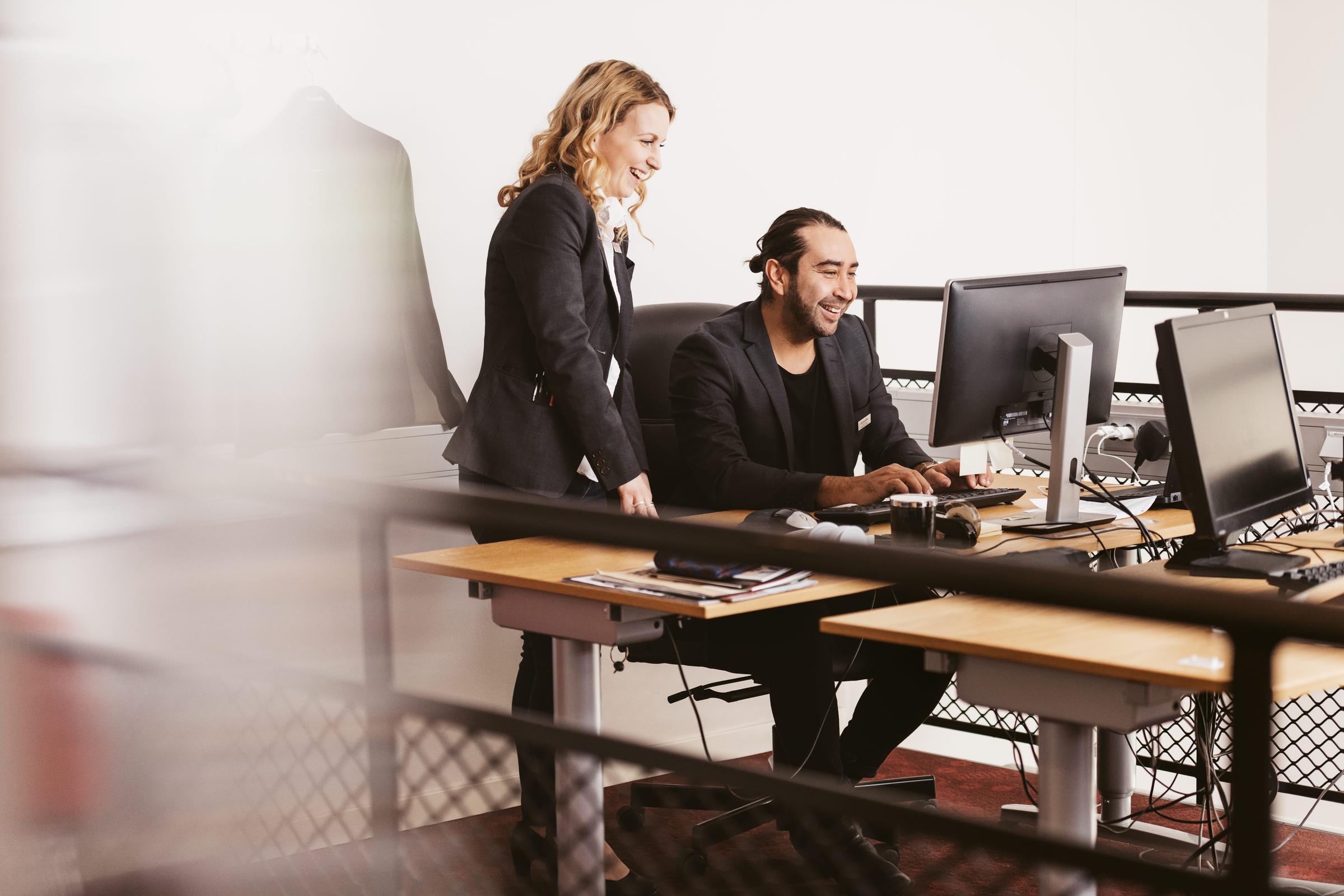 Team members working by the computer