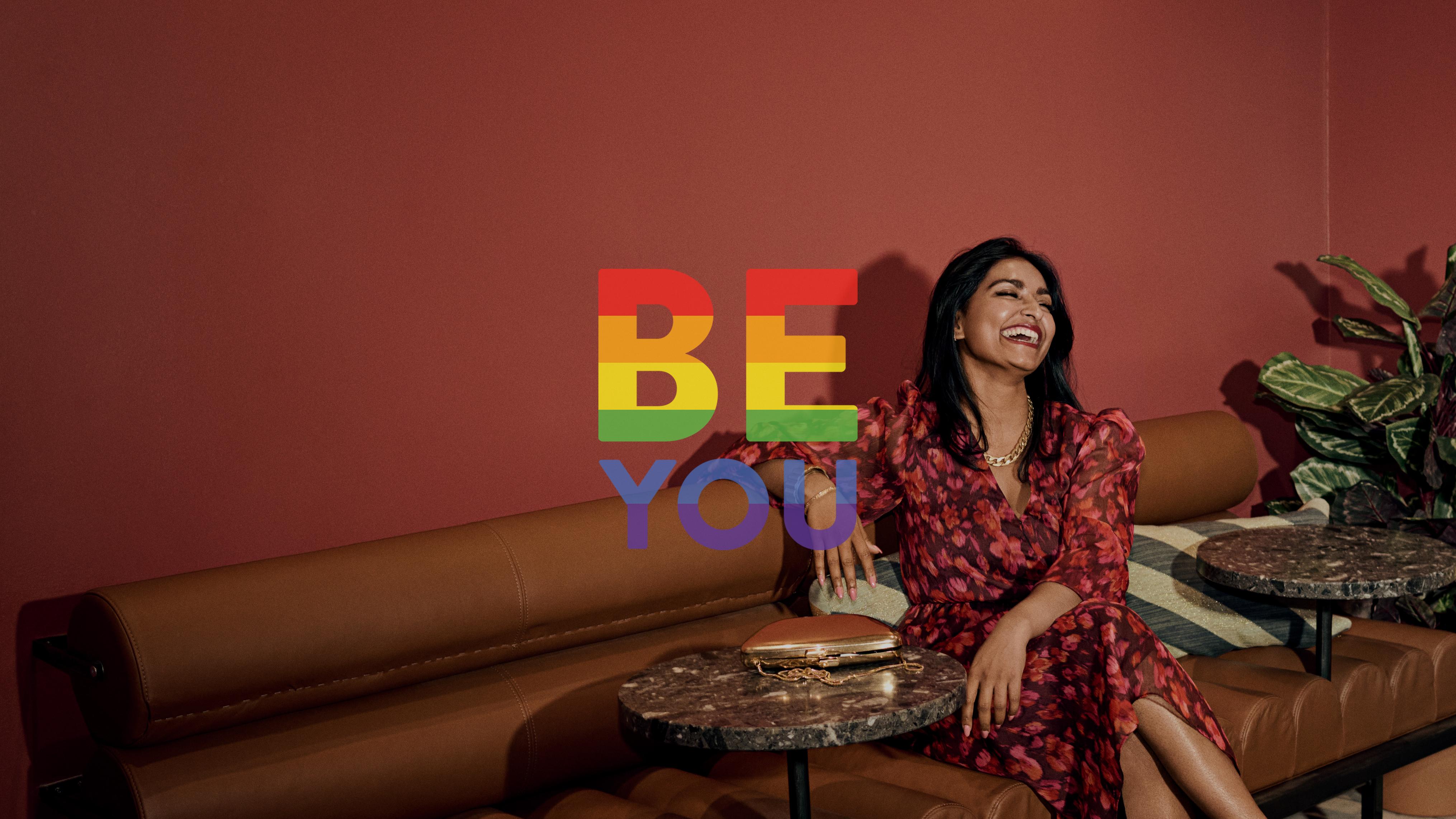 woman sitting on a sofa dressed in party attire