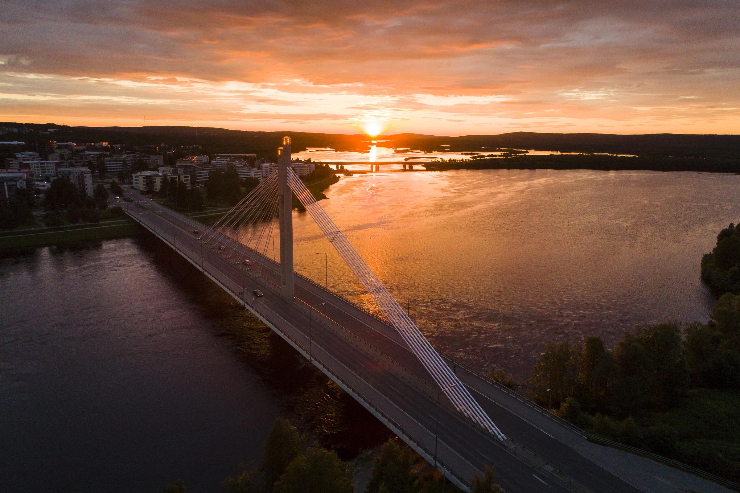 Midnight sun and Lumberjacks candle bridge in Rovaniemi Lapland Finland