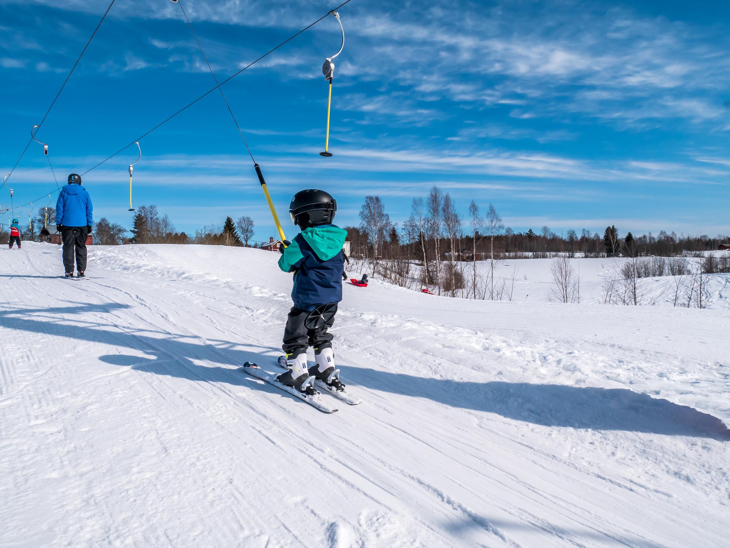 young kid riding in a ski lift Kungsberget