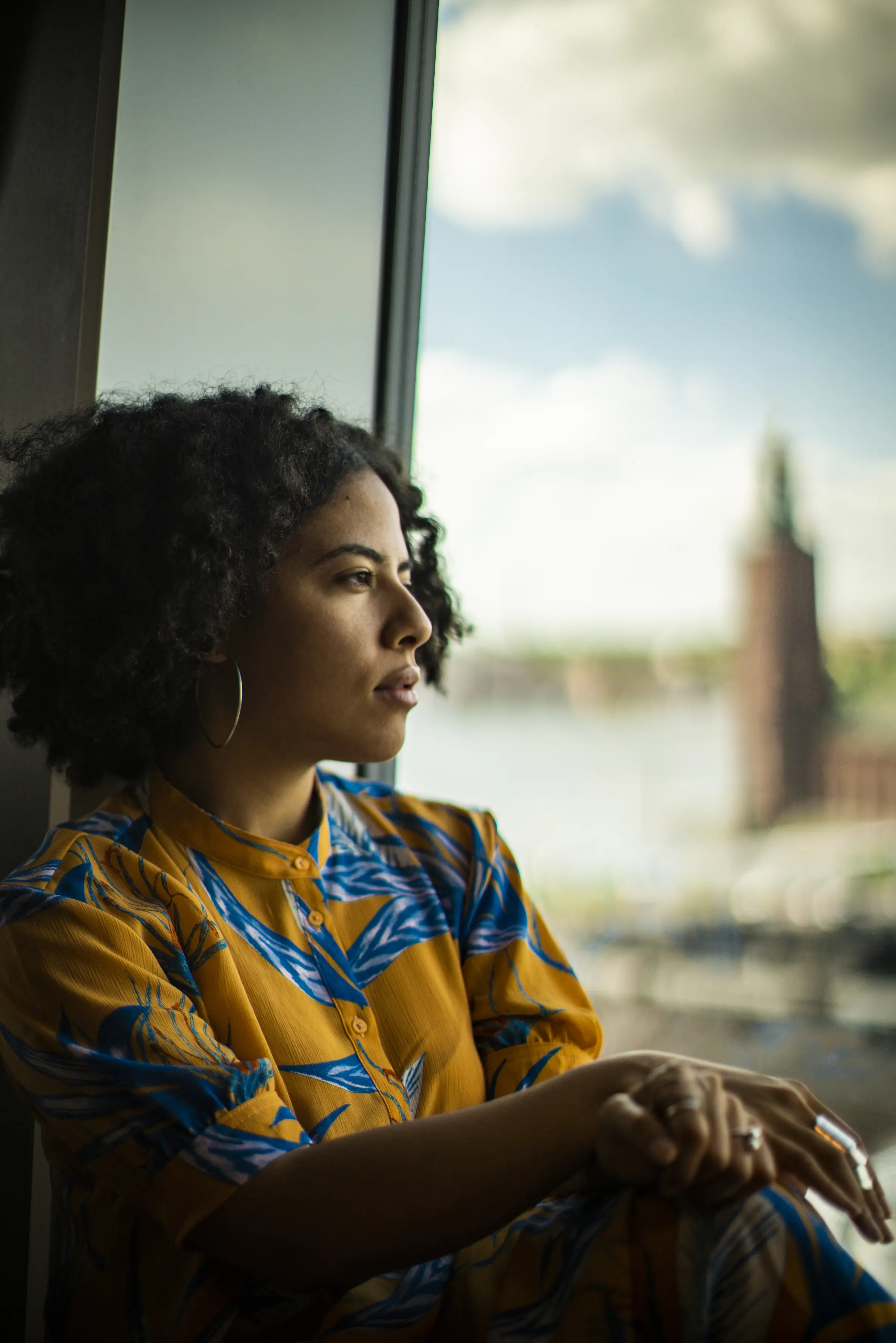 Woman looking out from a vindow