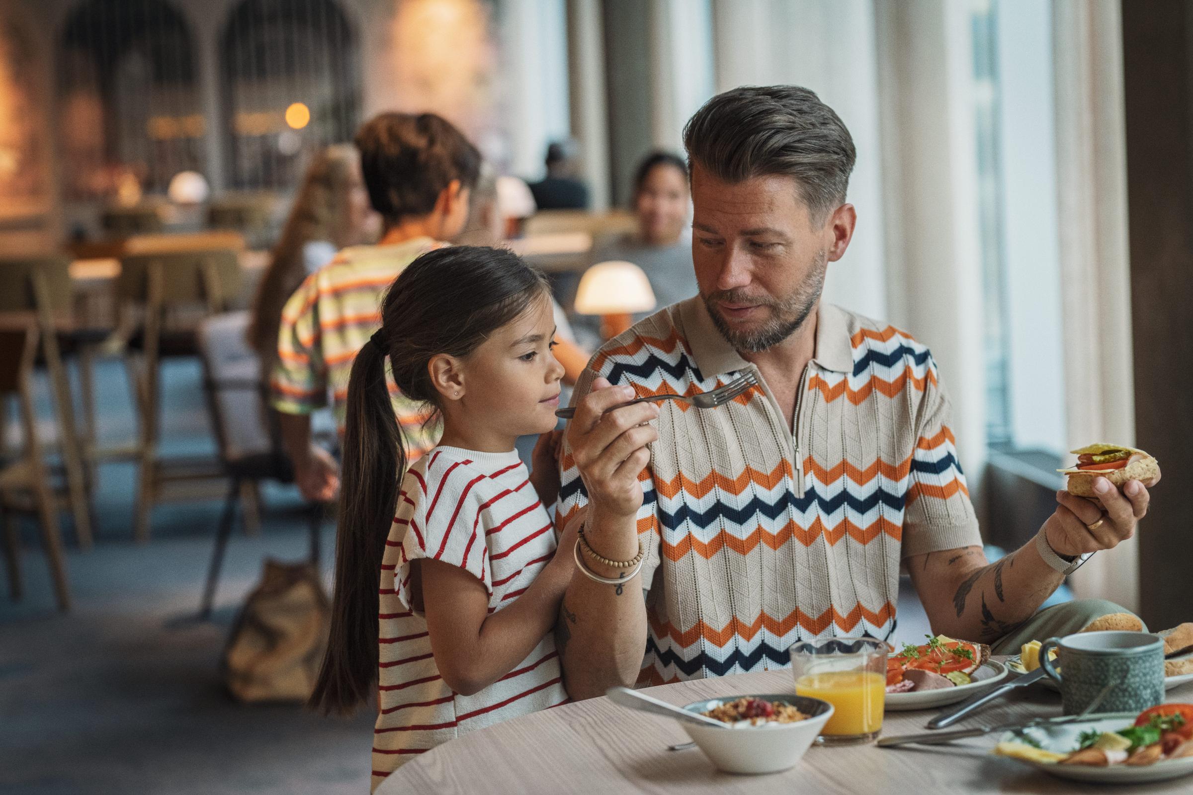 Dad and kid having breakfast