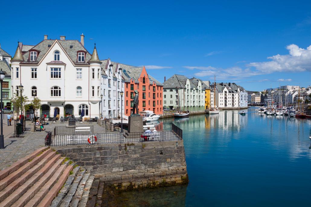 Old fishing warehouses in harbor, Alesund,